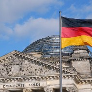 Gebäude Bundestag, Giebel und Glaskuppel, davor Fahne der Bundesrepublik Deutschland